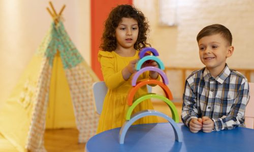 young-boy-girl-playing-indoors-with-eco-toys